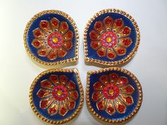 four decorative blue and red plates on a white surface