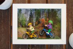 two children riding bikes on a wooden surface