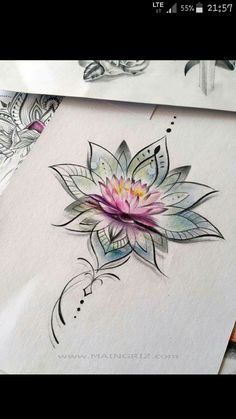 some watercolors are being used to create this beautiful flower tattoo design on paper