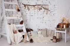 a room with white brick walls and wooden ladders, decorated with christmas decorations and teddy bears