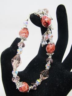 "These ROSE CERAMIC BEADS almost look like STONE! The color is so rich and the variations just beautiful! SO skillfully made! The ceramic beads (4 of them) are 10x14mm, along with clear and blush crystals, soft rose colored glass bicones, and some Czech glass. The bracelet adjusts from 6.5\" to 7.5\" in length and secures with a lobster clasp. I can lengthen/shorten somewhat upon request. The beadcaps, spacers, findings, chain and clasp are pewter and silver plate. I LOVE the colors and the way Pink Crystal Beaded Round Bracelets, Pink Crystal Bracelets With Round Beads, Adjustable Pink Glass Bracelets, Adjustable Pink Bracelets, Adjustable Glass Crystal Bracelet With Faceted Beads, Adjustable Pink Crystal Bracelet With Faceted Beads, Adjustable Pink Glass Beaded Bracelets, Pink Crystal Bracelets With Faceted Beads, Pink Czech Glass Bracelets With Faceted Beads