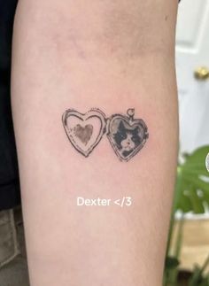 two heart shaped tattoos on the arm with an image of a dog and cat in them