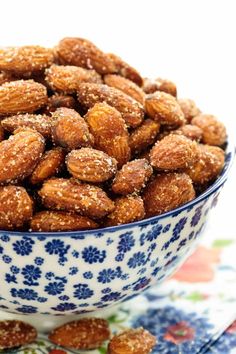 a blue and white bowl filled with almonds