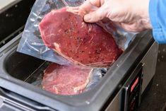 two raw meats are being put into an oven by someone holding one in their hand