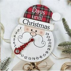 a wooden ornament with a santa clause on it's face and the words days until christmas