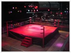 an empty wrestling ring with red lighting