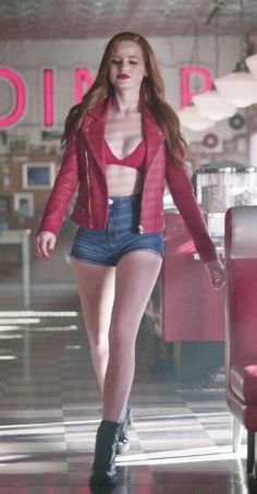 a woman in short shorts and a red jacket