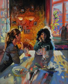 two women sitting at a table eating food