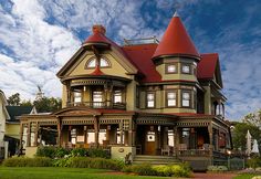 an old victorian style house with a red roof