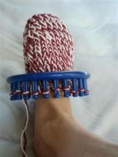 a person's foot with a red, white and blue hair brush on it