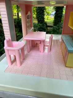 a doll house with furniture and accessories in the kitchen, including a table and chairs