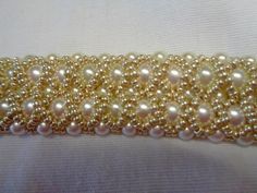 the beading is gold and white with pearls on it