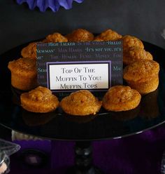 a black plate topped with muffins on top of a table