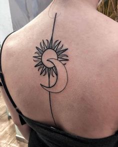 a woman's back with a sunflower tattoo on her upper arm and shoulder