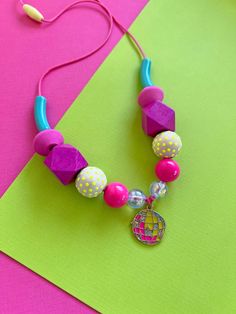 Elevate your cool kid's style with our fun colorful disco ball beaded necklace. Each necklace features charming hand-painted wooden beads, creating a unique and playful accessory that's sure to capture the wearer's imagination. Perfect for adding a touch of magic to any outfit, this accessory is sure to become a new favorite! 🌈 Vibrant Colors: Our necklaces are adorned with a rainbow of colors, making it the perfect statement piece for any outfit. We create each design using wooden beads that we hand paint with non-toxic acrylic paint, along with a variety of acrylic beads all in fun, bright color combinations. The disco ball charm adds a fun, eye catching element and makes this design extra special! 💪🏼 Quality: Each necklace is carefully handcrafted with love and attention to detail, e Multicolor Party Necklaces With Wooden Beads, Multicolor Wooden Beads Necklaces For Party, Adjustable Wooden Beaded Necklace For Parties, Playful Party Necklaces With Colorful Beads, Playful Adjustable Party Necklaces, Adjustable Playful Necklace For Parties, Playful Adjustable Necklaces For Parties, Adjustable Fun Party Necklaces, Fun Adjustable Party Necklaces