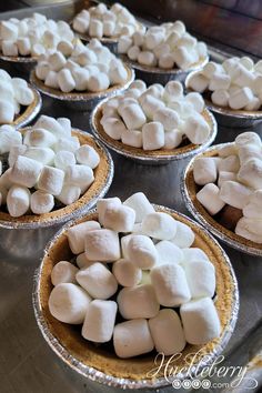 several pies filled with marshmallows on top of a table