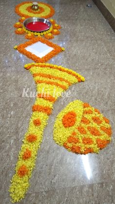 a decorated floor in the shape of a flower arrangement with an orange and yellow design on it