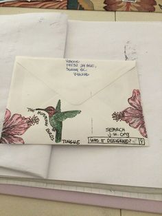 an open envelope with flowers on it