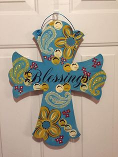 a wooden cross with the word blessing painted on it