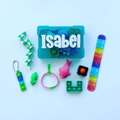 an assortment of toys and accessories on a white surface with the word sabel spelled in large letters