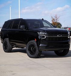 a black truck parked in a parking lot