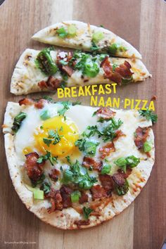 two flatbread pizzas with an egg and bacon on them, sitting on a wooden cutting board