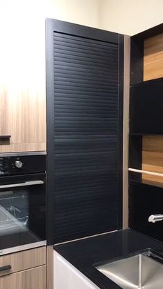 a kitchen with black counter tops and wooden cabinets