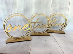 three metal signs that say one tastyie and one tastyie on wooden bases