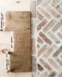 two pieces of wood sitting next to each other on top of a brick flooring