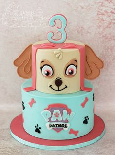 a birthday cake with a dog on top and the number three in front of it