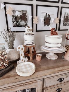 a table topped with two tiered cakes next to pictures