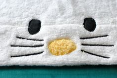 a close up of a towel with a cat face on it