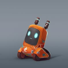 an orange robot sitting on top of a gray surface