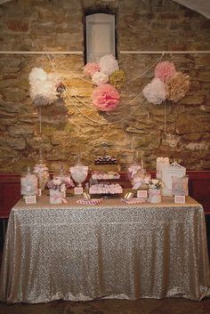 the table is covered with pink and white cakes