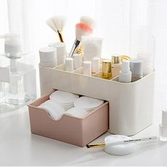 a white desk with makeup and toiletries in it