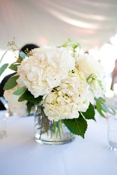 a vase filled with white flowers on top of a table