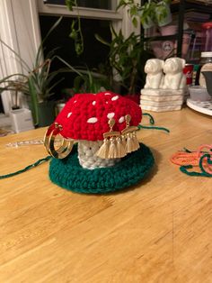 a red and white mushroom sitting on top of a wooden table