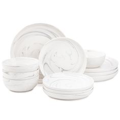 white marble dinnerware set with swirl design on the front and center, all in different sizes