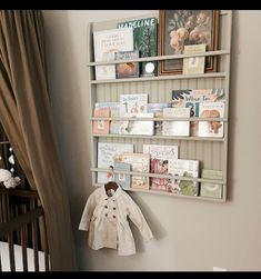 a baby's room with a crib and bookshelf on the wall