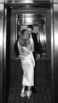 a man and woman standing in an elevator