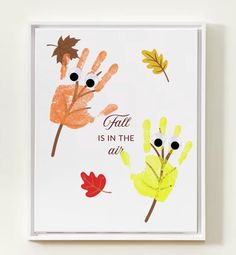 an art print with the words fall is in the air and leaves painted on it