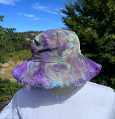 Ice dye frayed edge bucket hat. Made from soft cotton canvas. One size fits most adults. Approximately 23 inches hat b4 Adjustable Washed Hats For Beach, Beach Hat With Adjustable Washed Look, Adjustable Washed Hat For The Beach, Casual Hats With Fringe And Curved Brim, Adjustable Washed Beach Hat, Washed Cotton Bucket Hat With Curved Brim, Casual Adjustable Sun Hat With Fringe, Pre-washed Short Brim Summer Hats, Pre-washed Summer Hat With Short Brim