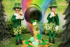 two green leprechauns standing next to a pile of gold coins