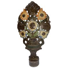 a decorative vase with sunflowers in it