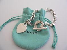 Overview:Offered for sale is a wonderful and gorgeous Tiffany & Co. Sterling Silver Heart Toggle bracelet.  Definitely a Tiffany piece that you will get your money's value for.  It works perfectly with pretty much any attire your put on, AND is a great statement piece.  The chain for this specific bracelet very substantial, and the pretty Tiffany heart just goes perfectly with it.   It is the perfect bracelet that fits a lifestyle on the go -- can be worn to pretty much any occasion!  It i Tiffany Charm Bracelet, Heart Toggle Necklace, Tiffany And Co Bracelet, Tiffany And Co Necklace, Cheap Silver Rings, Tiffany Bracelets, Silver Necklaces Women, Toggle Necklace, Egyptian Jewelry