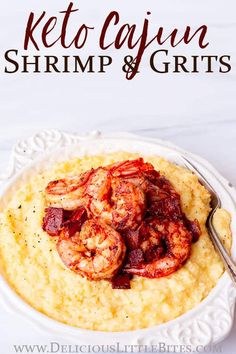 shrimp and grits in a white bowl with lemon wedges on the side for garnish