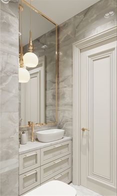 a bathroom with marble walls and white cabinets