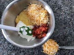 a silver bowl filled with different types of food