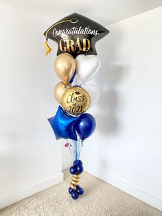 a graduation cap and balloons in the shape of a graduate's cap