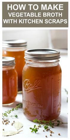 three jars filled with liquid sitting on top of a white table next to leaves and spoons